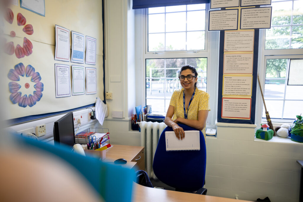 An over-the-shoulder point of view of two teachers having a conversation as they await the arrival of their pupils in a school in Hexham in the North East of England.