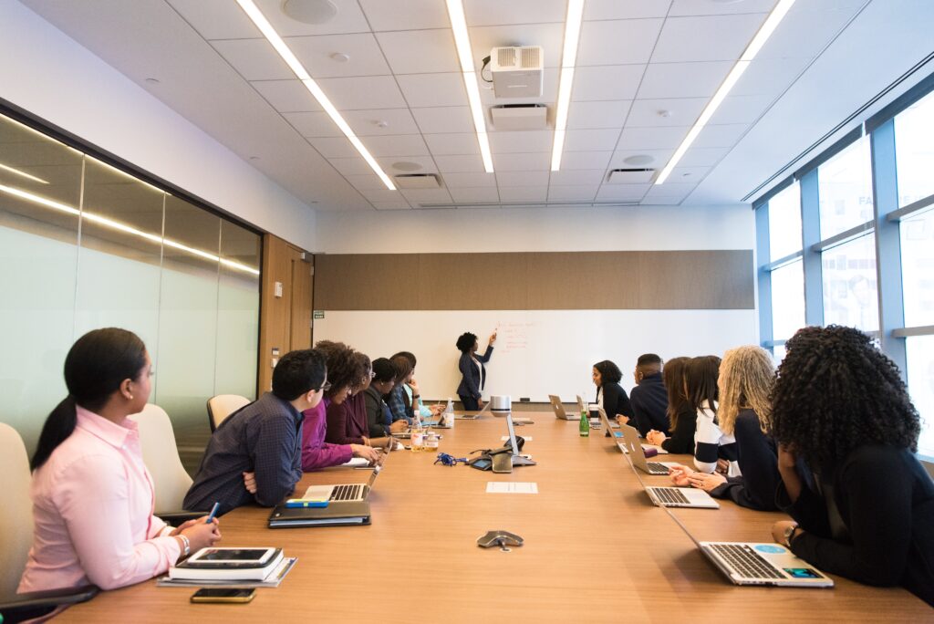 Group watching presenter in board room 